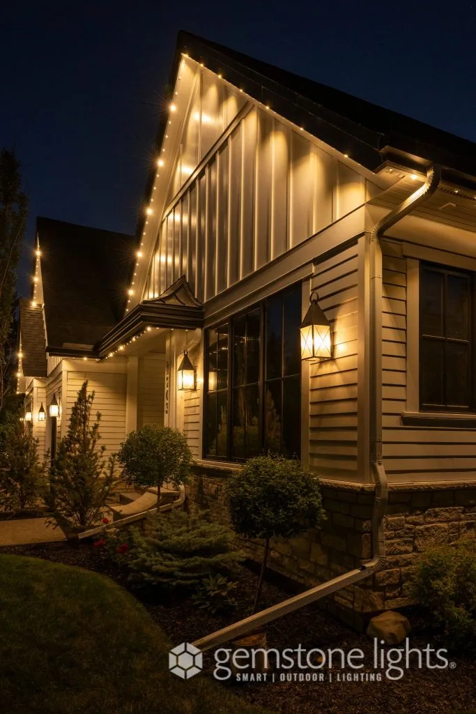 Warm string lights illuminate a charming house during the night