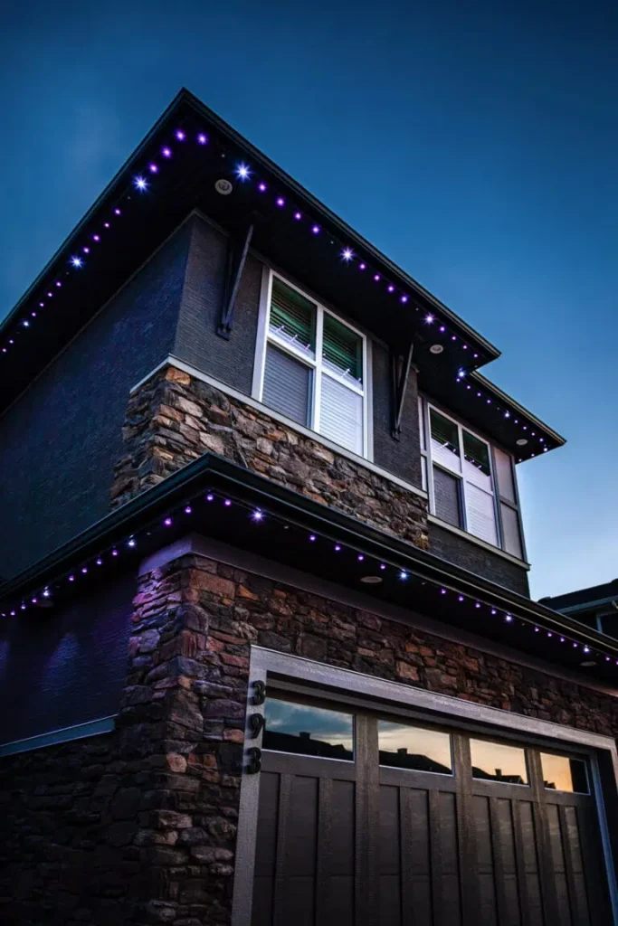 A modern house is adorned with vibrant purple lights against a twilight sky