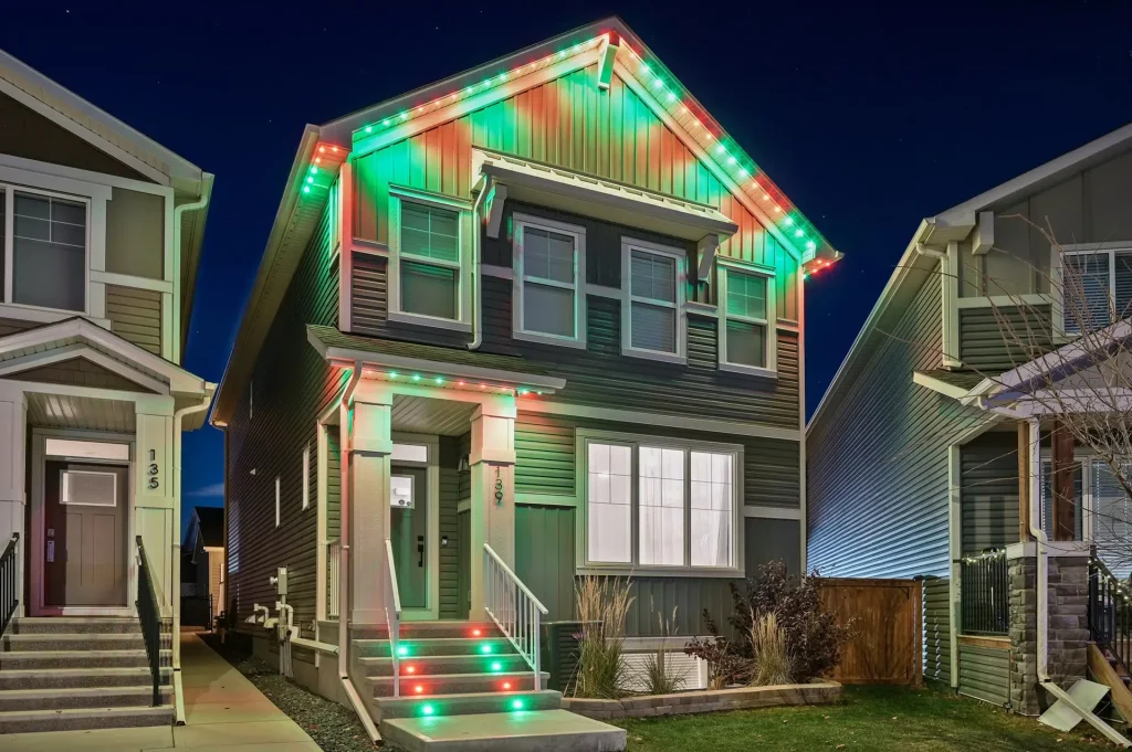 A house is brightly decorated with red and green lights for the holiday season