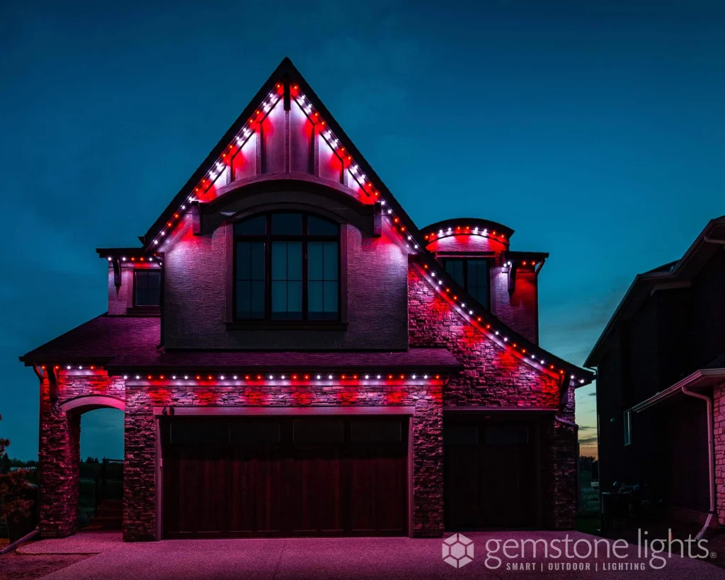A beautifully lit house shines with colorful lights against a twilight sky